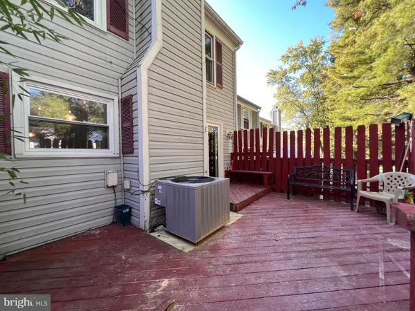 a view of a backyard with chairs and wooden fence