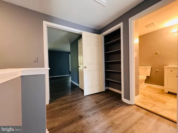a view of a kitchen with wooden floor and a sink