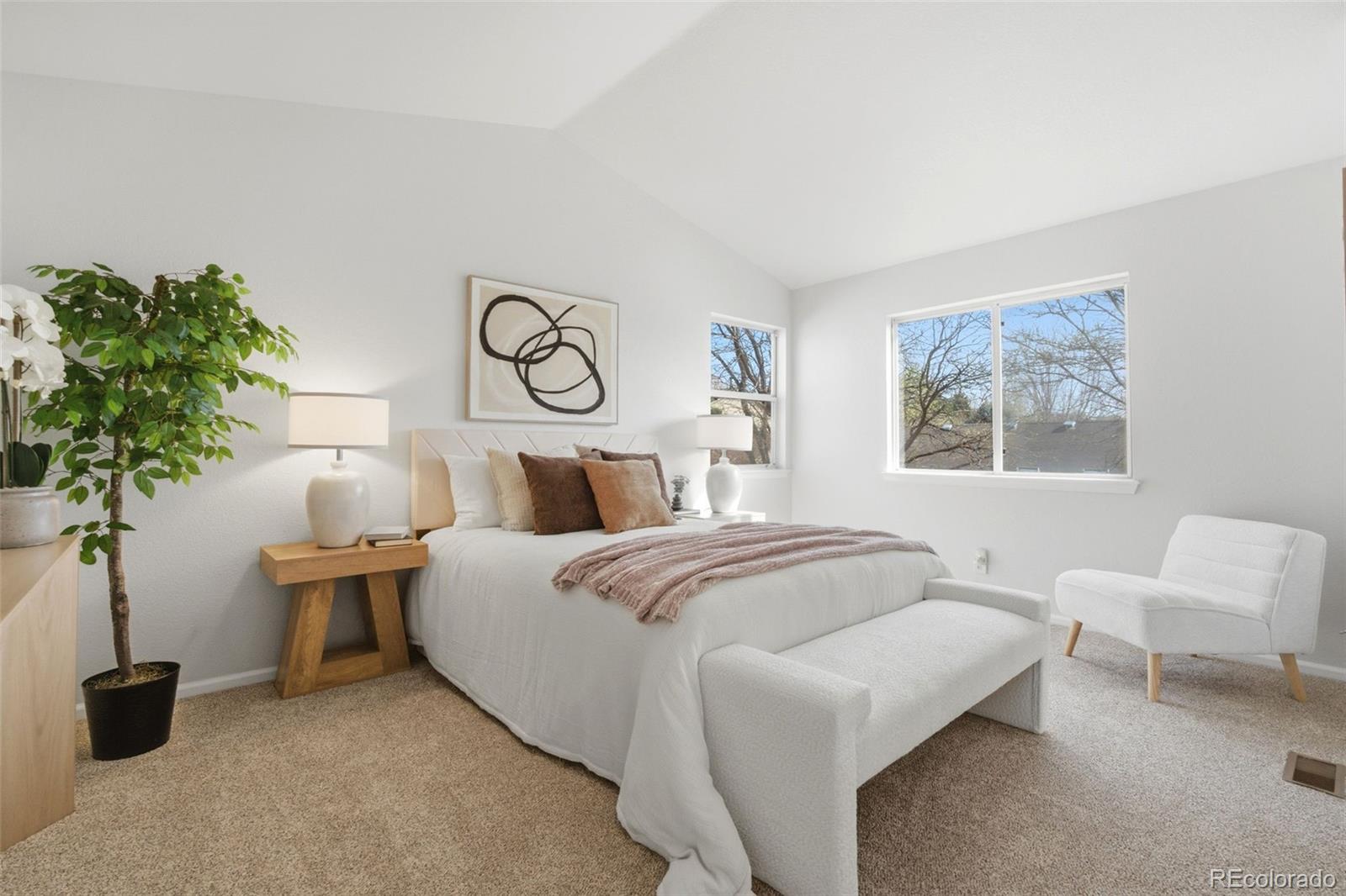 2164 South Waco Street Aurora, CO 80013 - Photo 31 of 50 a bedroom with a bed and a potted plant