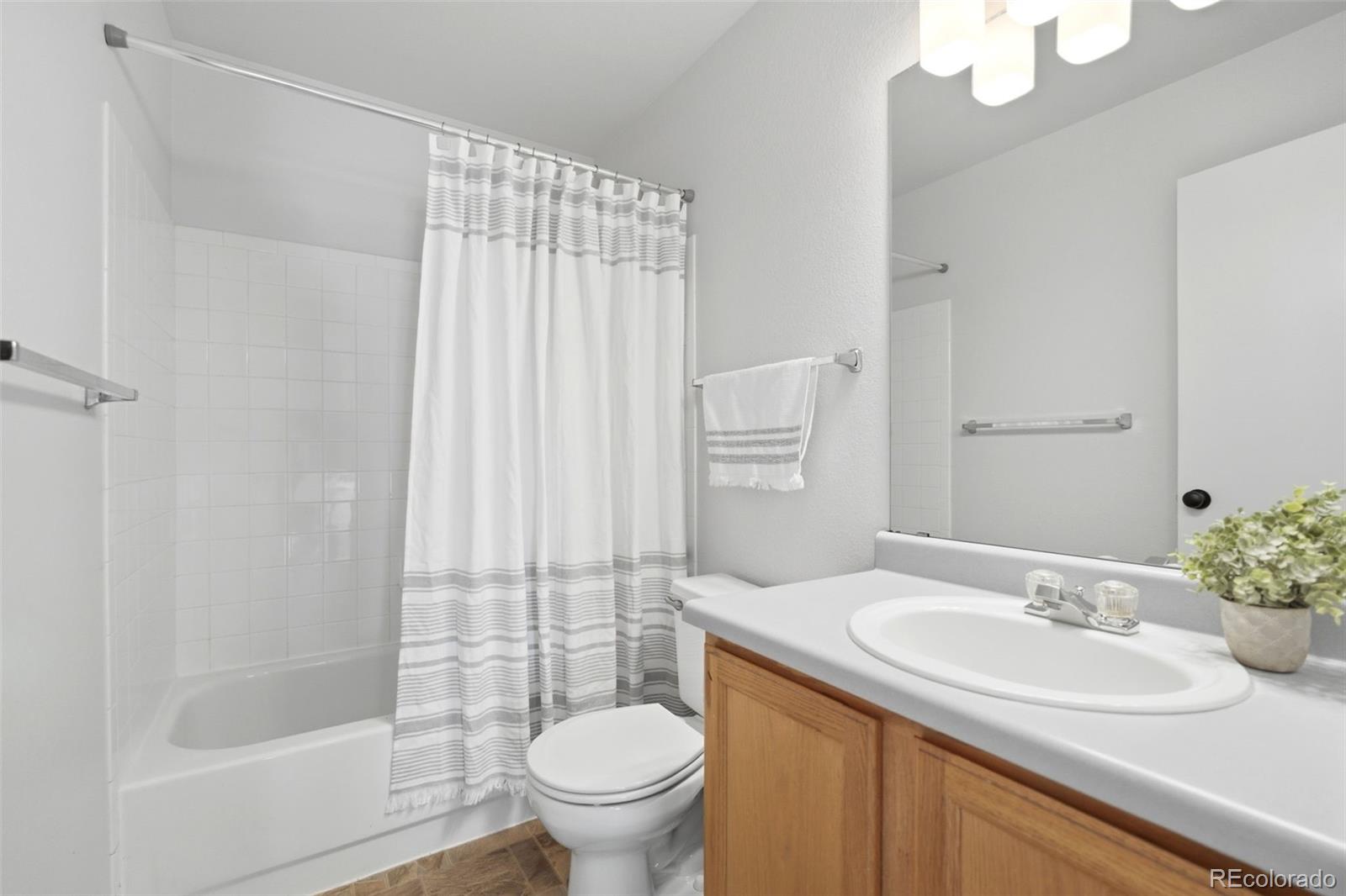 2164 South Waco Street Aurora, CO 80013 - Photo 41 of 50 a bathroom with a sink toilet and shower
