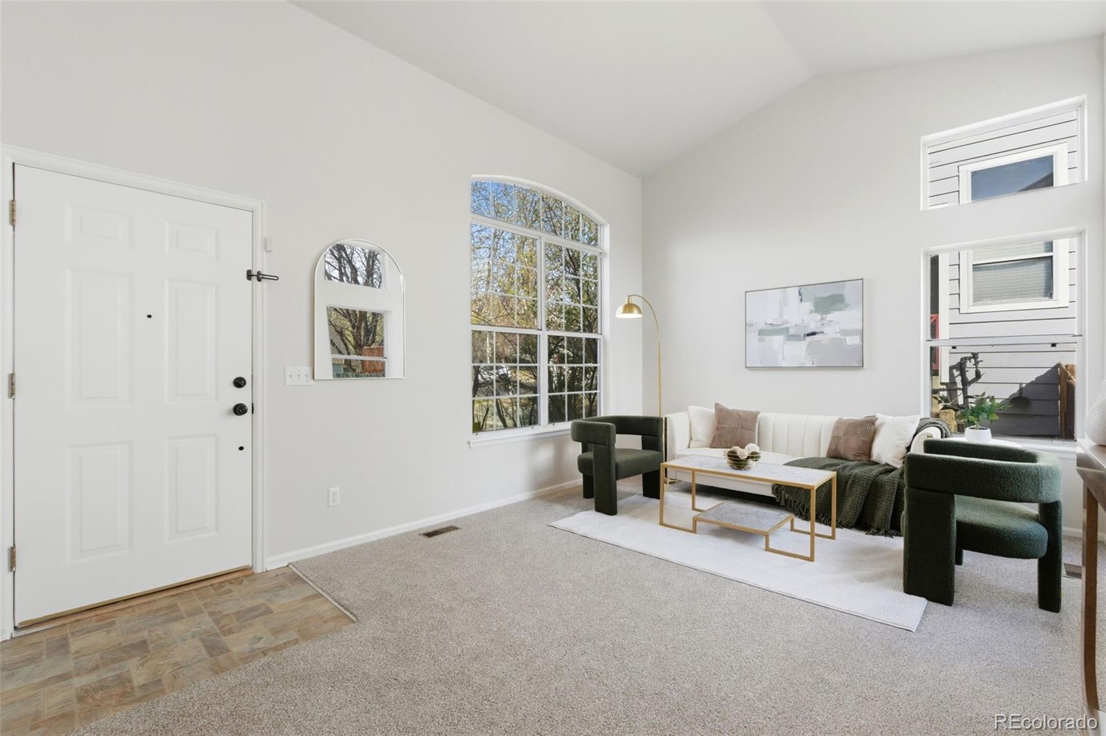 2164 South Waco Street Aurora, CO 80013 - Photo 7 of 50 a living room with furniture and windows