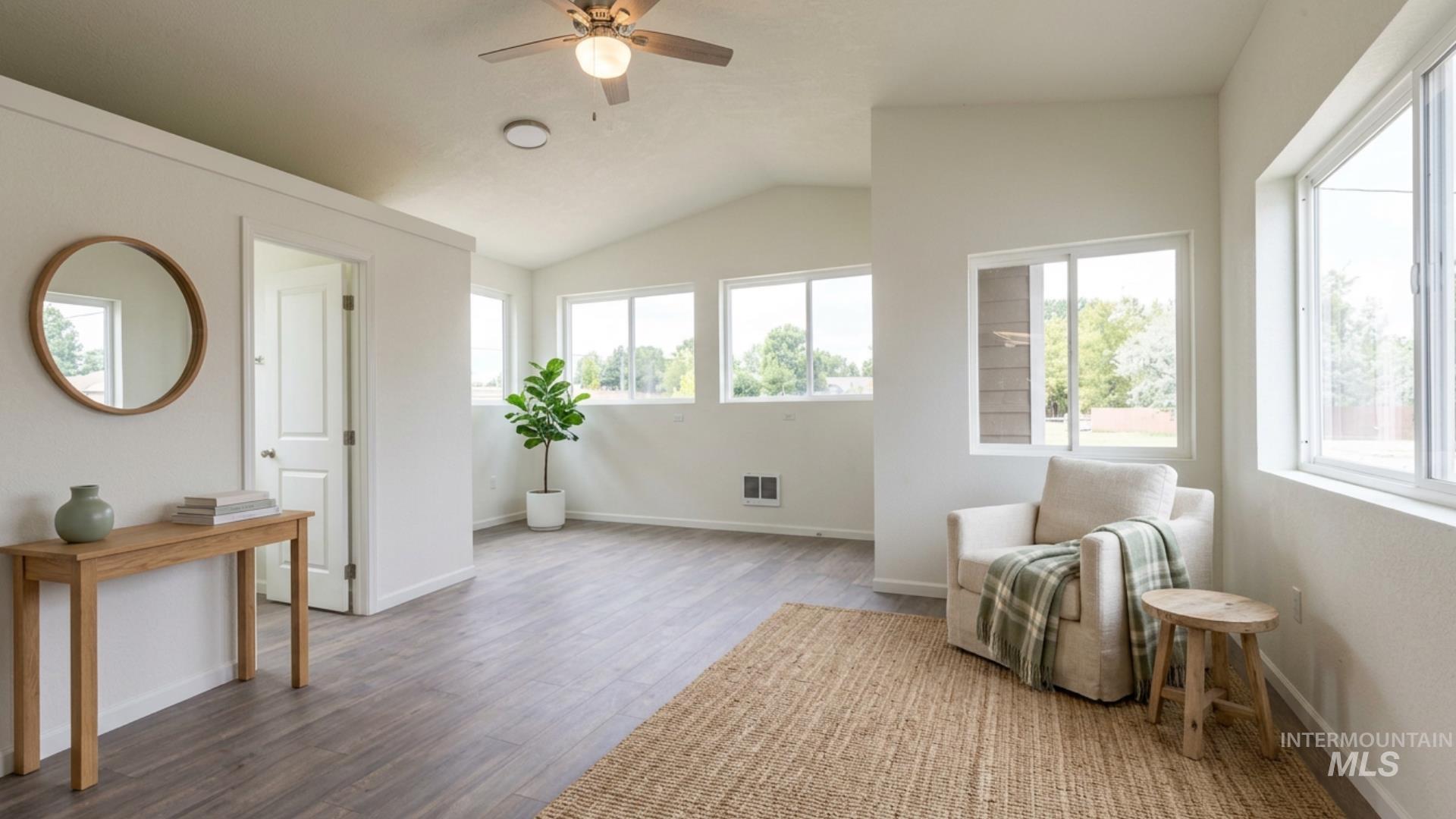 17028 Lower Pleasant Ridge Road Caldwell, ID 83607 - Photo 18 of 21 Spacious interior room featuring vaulted ceilings, wood-finish flooring, recessed lighting, and multiple windows with white frames