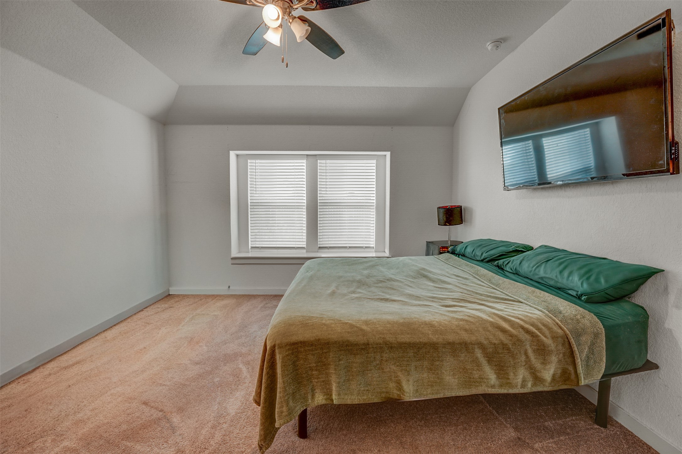 5806 Aviano Road Round Rock, TX 78665 - Photo 22 of 29 Well-lit sleeping quarters with a vaulted ceiling and soft carpeting.
