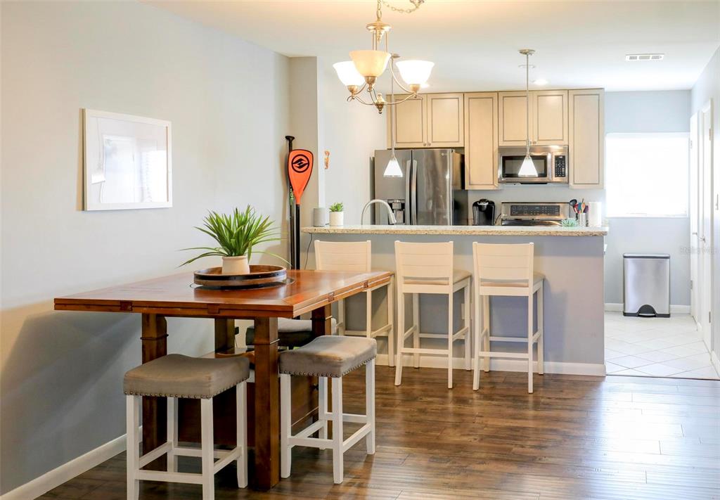 8911 Blind Pass Road, Unit 321 St. Pete Beach, FL 33706 - Photo 11 of 55 a dining room with furniture and wooden floor
