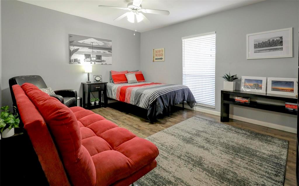 8911 Blind Pass Road, Unit 321 St. Pete Beach, FL 33706 - Photo 21 of 55 a bedroom with bed and a couch