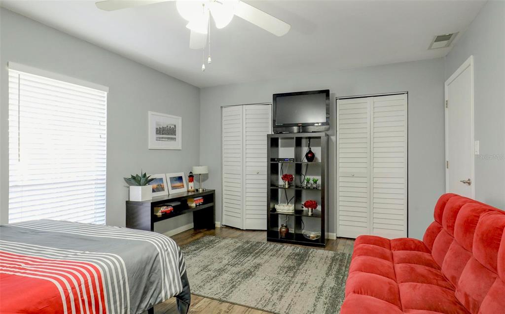 8911 Blind Pass Road, Unit 321 St. Pete Beach, FL 33706 - Photo 23 of 55 a bedroom with a bed and a television