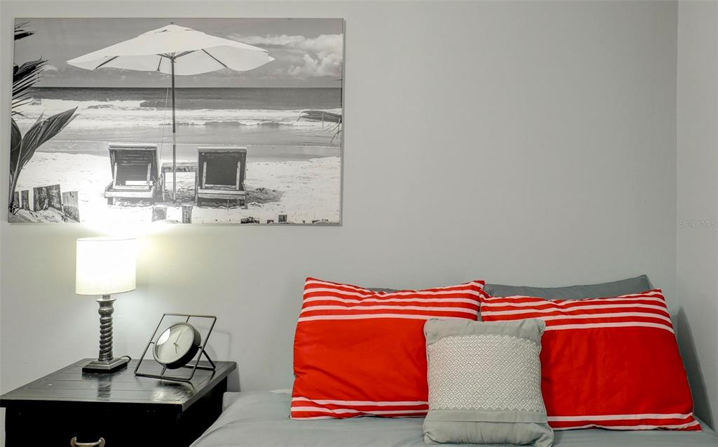 8911 Blind Pass Road, Unit 321 St. Pete Beach, FL 33706 - Photo 25 of 55 a bedroom with a bed and window
