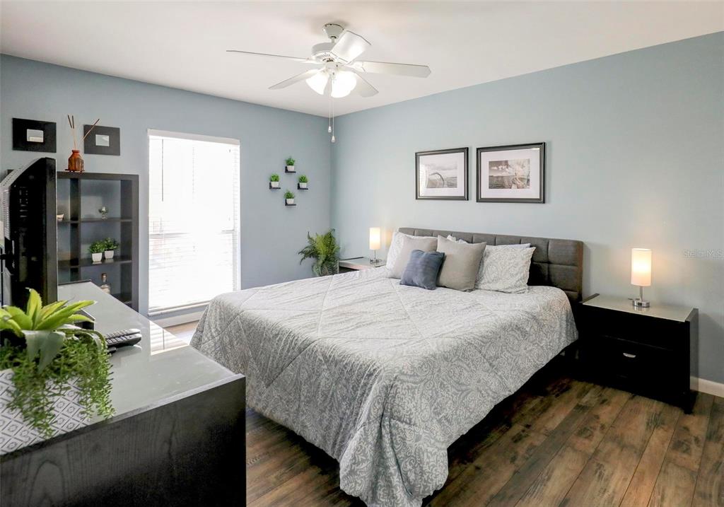 8911 Blind Pass Road, Unit 321 St. Pete Beach, FL 33706 - Photo 27 of 55 a bedroom with a bed and a chandelier