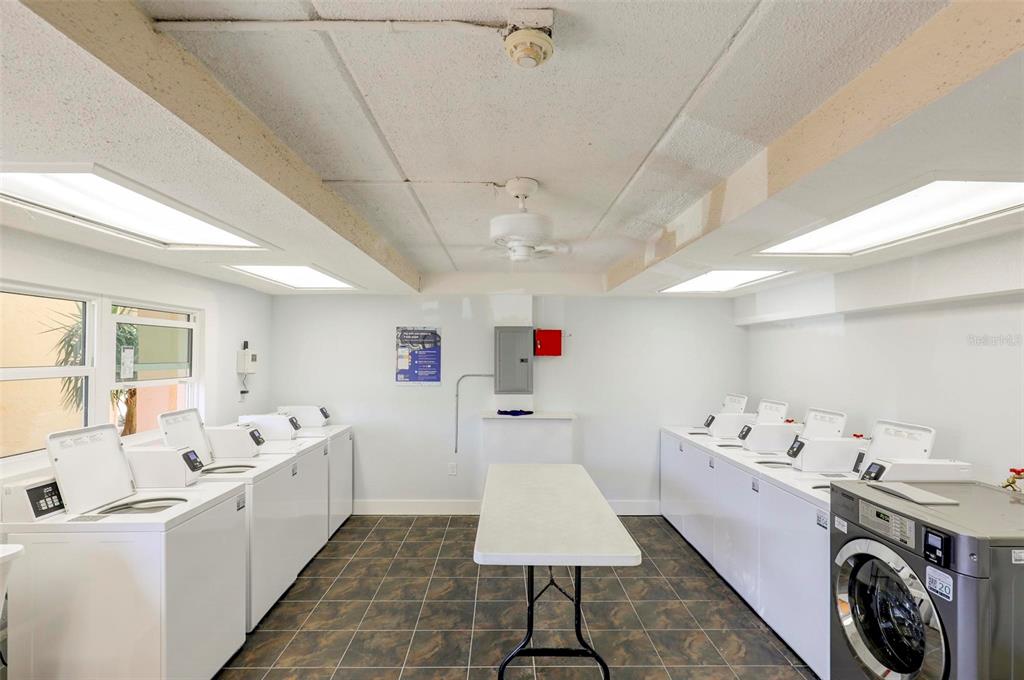 8911 Blind Pass Road, Unit 321 St. Pete Beach, FL 33706 - Photo 39 of 55 a utility room with a washer and dryer