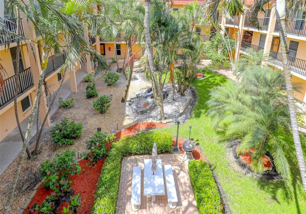 8911 Blind Pass Road, Unit 321 St. Pete Beach, FL 33706 - Photo 42 of 55 an aerial view of a house with a yard and garden