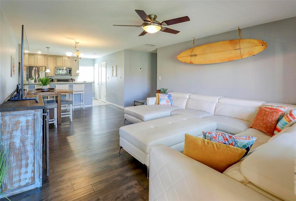8911 Blind Pass Road, Unit 321 St. Pete Beach, FL 33706 - Photo 8 of 55 a living room with furniture a ceiling fan and a rug