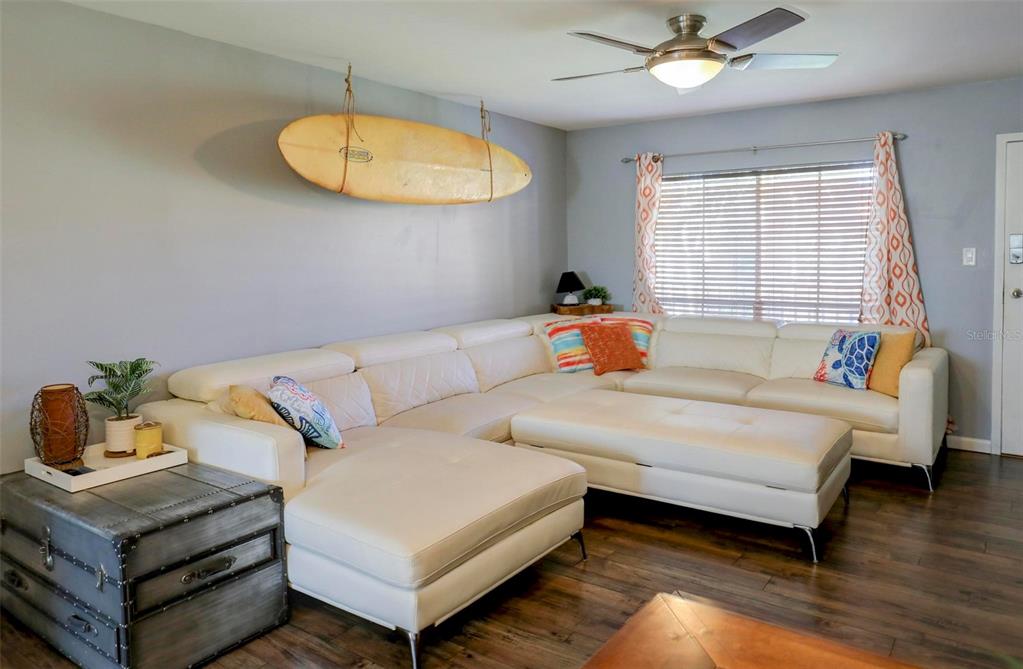 8911 Blind Pass Road, Unit 321 St. Pete Beach, FL 33706 - Photo 9 of 55 a bedroom with a bed and wooden floor