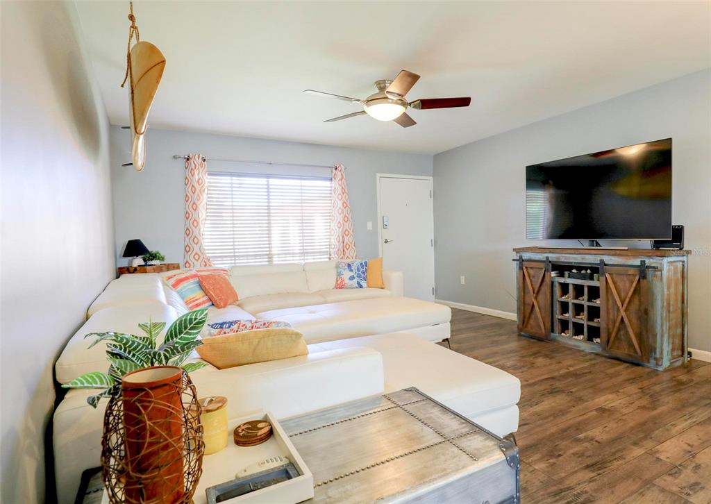 8911 Blind Pass Road, Unit 321 St. Pete Beach, FL 33706 - Photo 10 of 55 a living room with furniture and a flat screen tv