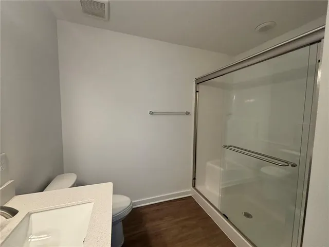 a bathroom with a shower and toilet