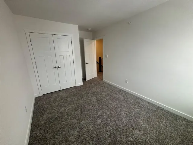 a view of an empty room and closet area
