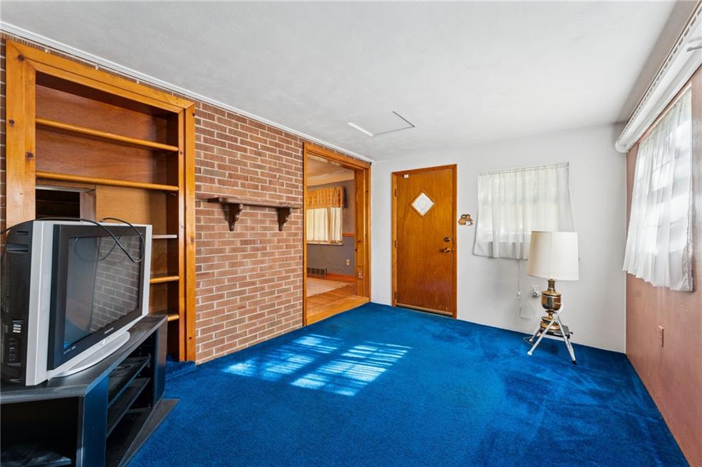 1237 Circle Drive Pittsburgh, PA 15221 - Photo 23 of 40 a view of an empty room with window and wooden floor