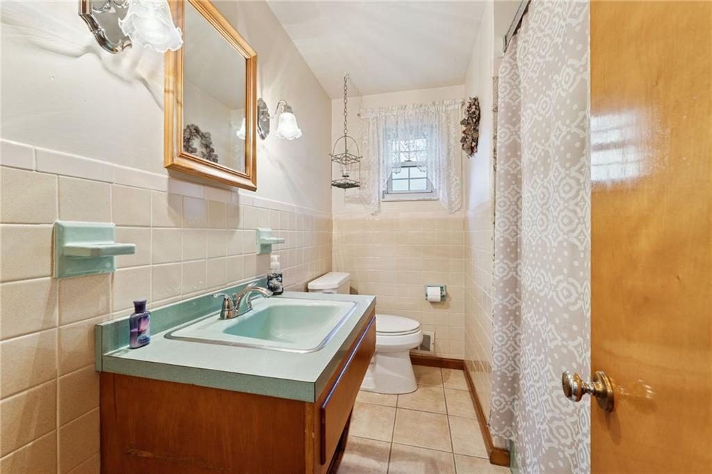 1237 Circle Drive Pittsburgh, PA 15221 - Photo 24 of 40 a bathroom with a sink and a mirror