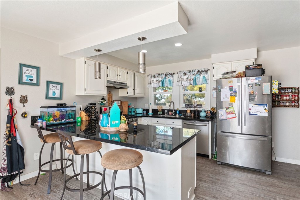 38855 Howard Road Anza, CA 92539 - Photo 20 of 54 a kitchen with stainless steel appliances granite countertop a refrigerator and a stove top oven
