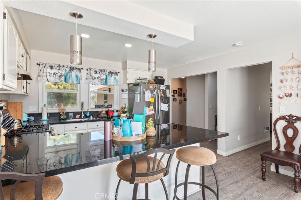 38855 Howard Road Anza, CA 92539 - Photo 21 of 54 a kitchen with refrigerator and chairs
