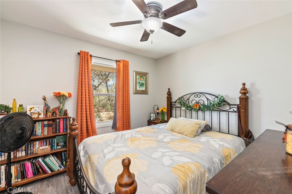 38855 Howard Road Anza, CA 92539 - Photo 22 of 54 a bedroom with a bed a bookshelf and a large window