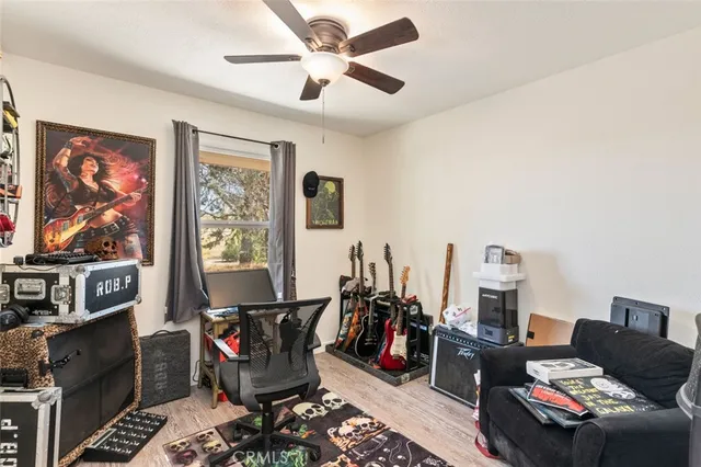 a bedroom with a bed dresser and a flat screen tv