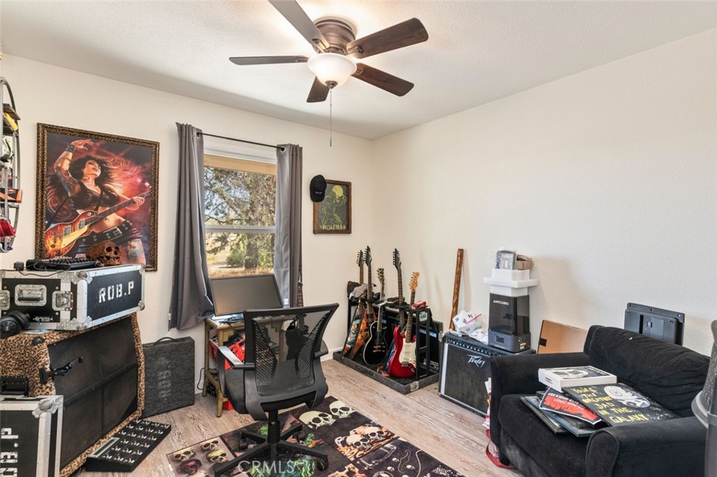 38855 Howard Road Anza, CA 92539 - Photo 24 of 54 a living room with furniture a flat screen tv and a window