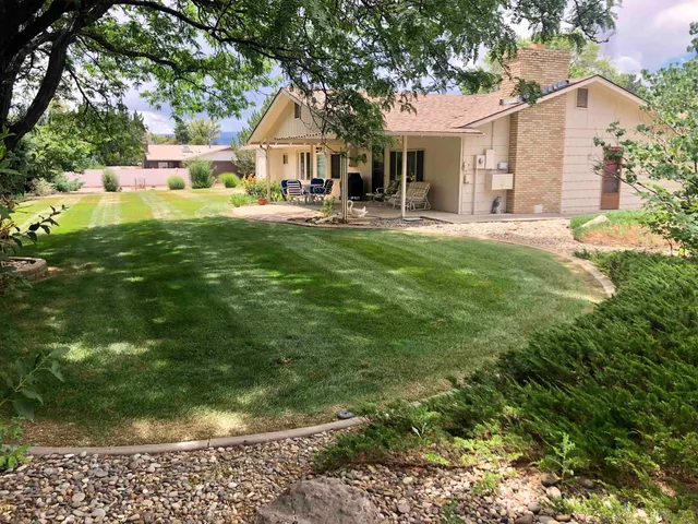 a front view of house with yard and green space