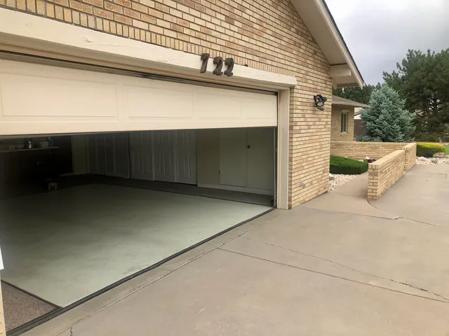 a living room with furniture kitchen view and a large window