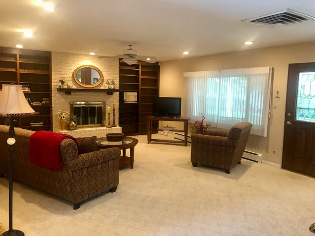 a bed sitting in a bedroom next to a bathroom sink