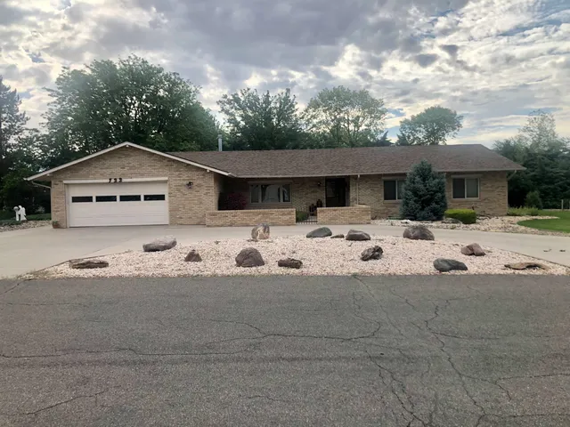 a view of a white house with a yard covered in snow