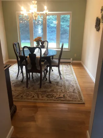a view of a dining room with furniture window and wooden floor