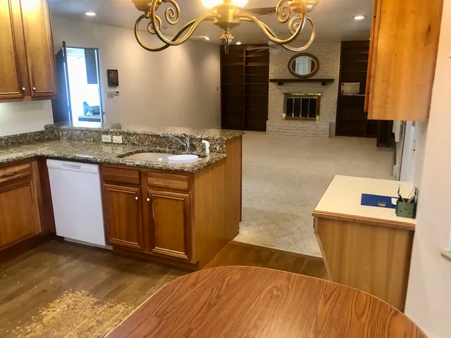 a view of a kitchen with a sink and a mirror