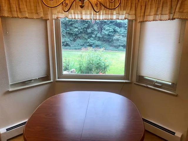 a view of a room with racks on the wall and a window