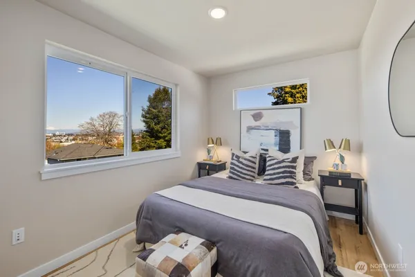 a bedroom with a bed and a painting on the wall