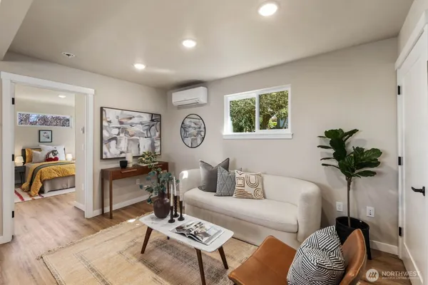 a living room with furniture and a potted plant
