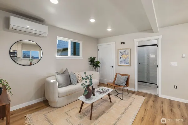 a living room with furniture and a mirror