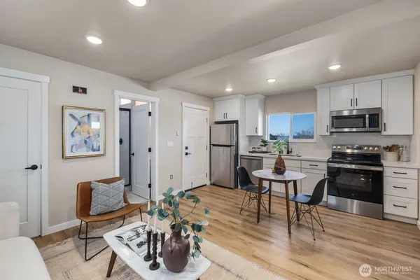 a living room with stainless steel appliances kitchen island granite countertop furniture and a view of kitchen