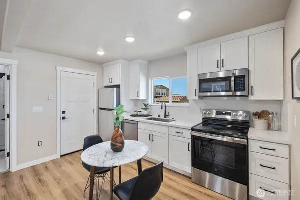 a kitchen with a sink stove and refrigerator