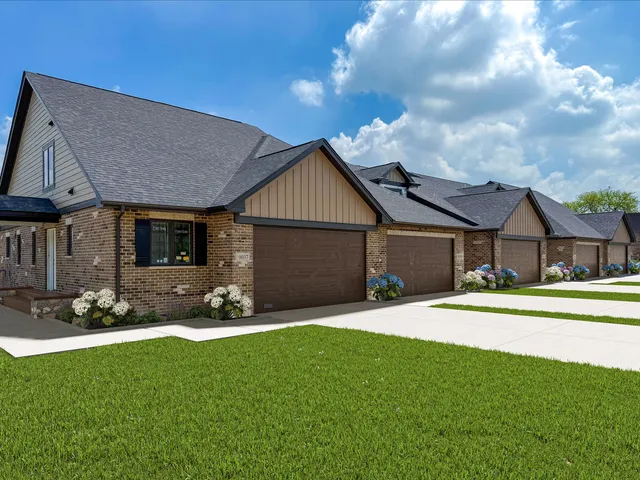 a front view of a house with a garden and yard