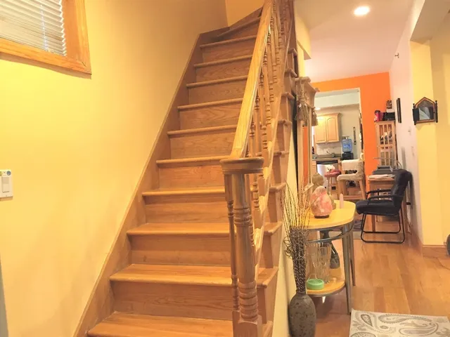 a view of a balcony with dining table and chairs