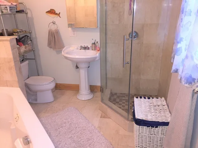 a bathroom with a sink toilet and shower