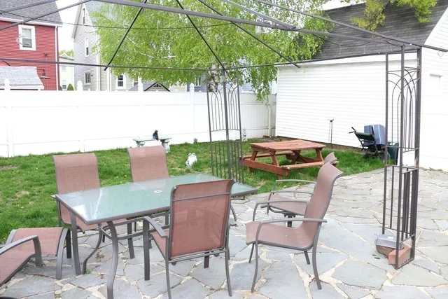 a patio with table and chairs