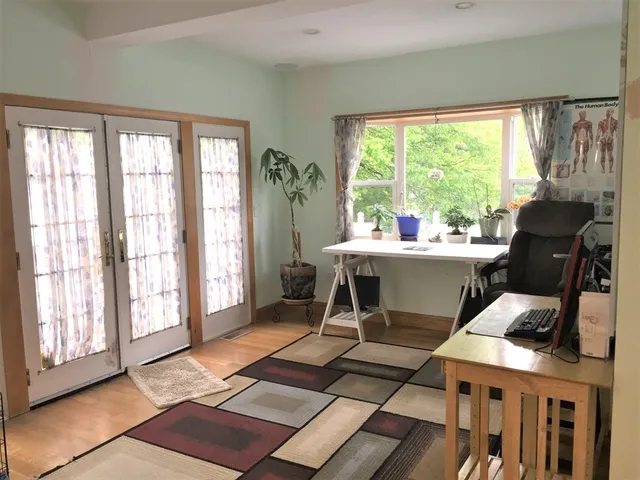 a room with gym equipment and large windows