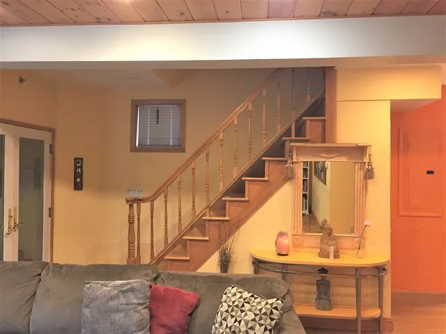 a view of entryway and hall with wooden floor