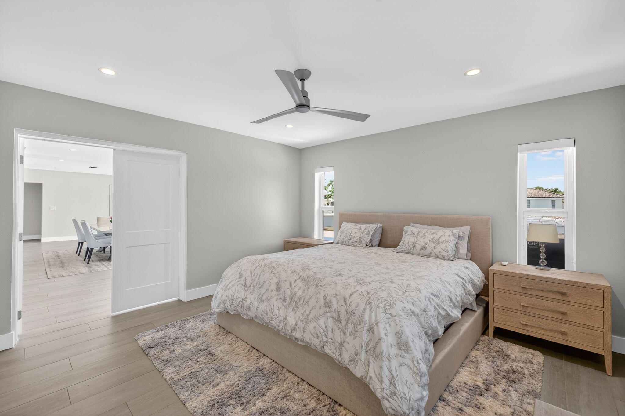 4460 Northeast 26th Avenue Lighthouse Point, FL 33064 - Photo 20 of 55 a bedroom with a bed and a chandelier