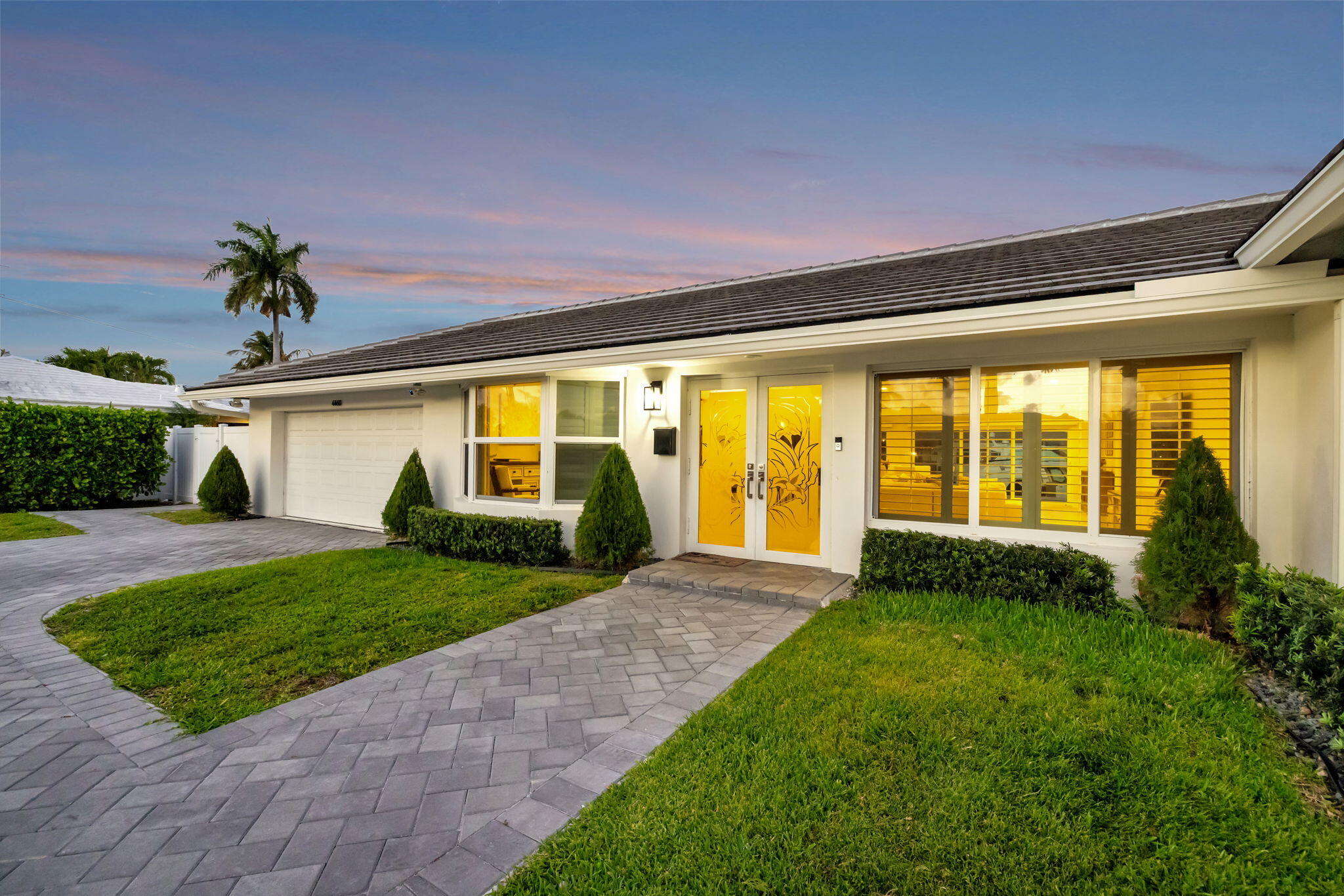 4460 Northeast 26th Avenue Lighthouse Point, FL 33064 - Photo 50 of 55 a front view of a house with garden