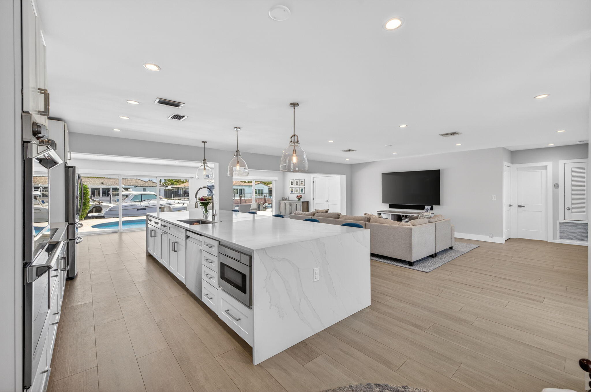 4460 Northeast 26th Avenue Lighthouse Point, FL 33064 - Photo 9 of 55 a large white kitchen with stainless steel appliances