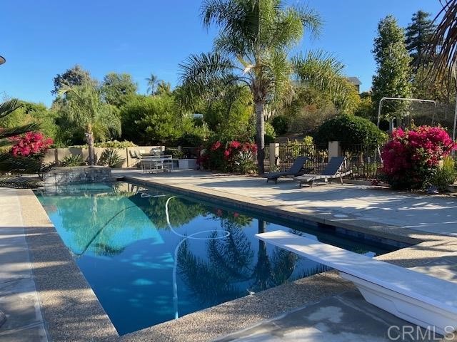 a view of a swimming pool with sitting area