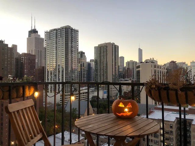 a view of a balcony with a table and chairs and wooden fence