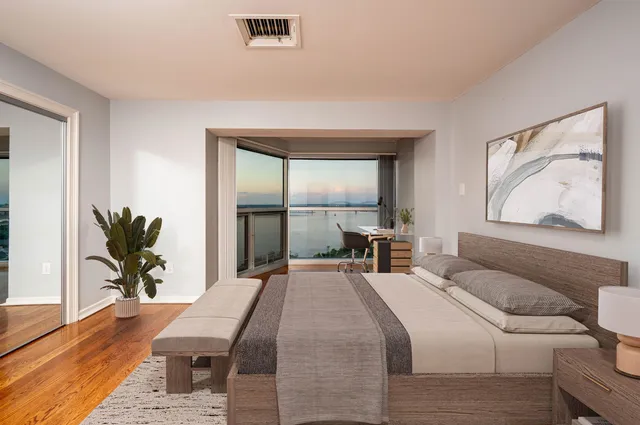 an empty room with wooden floor and a window